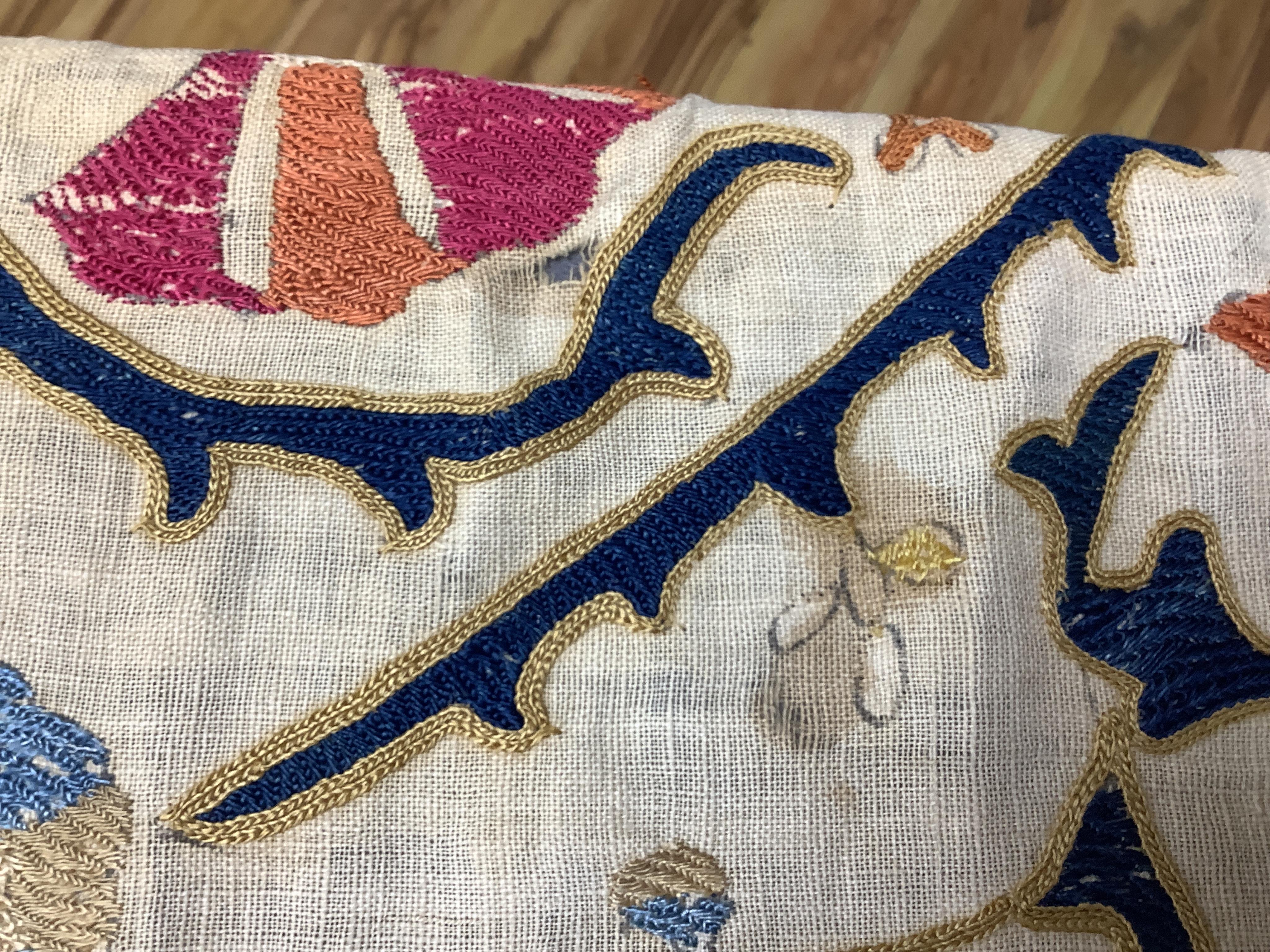 A 19th century Uzbekistan Suzani, hand embroidered hanging. Made from hand woven linen panels each approximately 28cm wide x 167cm long. Hand embroidered with silk hand dyed threads, in orange, red, blue and yellows, usi
